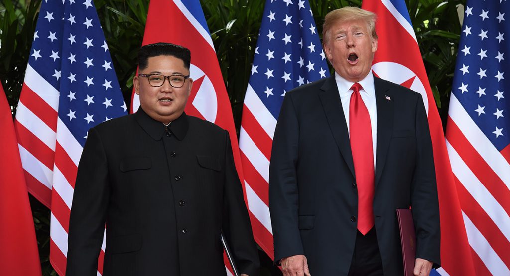 North Korea's leader Kim Jong Un (L) poses with US President Donald Trump (R) after taking part in a signing ceremony at the end of their historic US-North Korea summit, at the Capella Hotel on Sentosa island in Singapore on June 12, 2018. - Donald Trump and Kim Jong Un became on June 12 the first sitting US and North Korean leaders to meet, shake hands and negotiate to end a decades-old nuclear stand-off. (Photo by Anthony WALLACE / POOL / AFP)        (Photo credit should read ANTHONY WALLACE/AFP/Getty Images)
